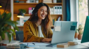Smiling remote employee using HR software on a laptop while working from home — illustrating effective work-from-home management tools for HR teams